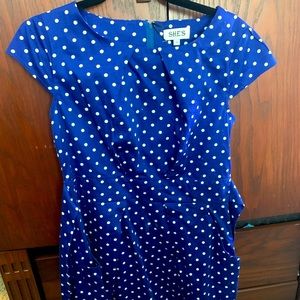 Blue with white polka dots dress. Has front ties to waist. Just above the knee.